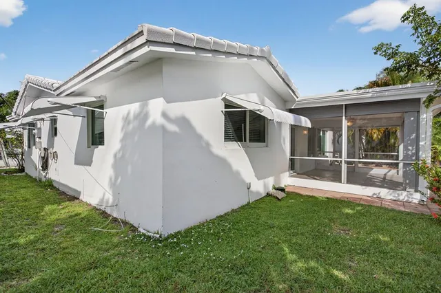 a view of a house with a yard and sitting area
