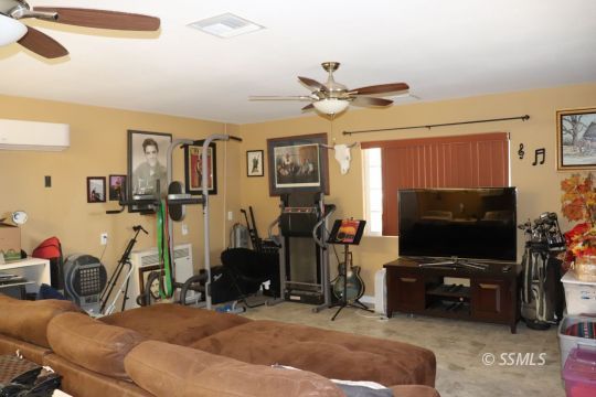 1624 South Farragut Street Ridgecrest, CA 93555 - Photo 30 of 43 a room with gym equipment and a flat screen tv