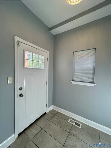 a view of a house with wooden deck and a yard