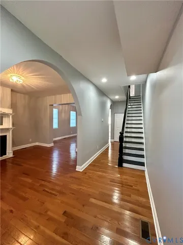 a view of entryway and hall with wooden floor