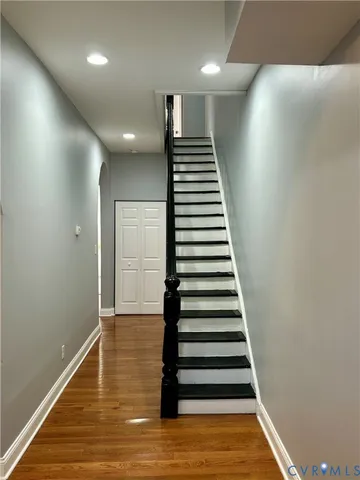 a view of entryway and hall with wooden floor