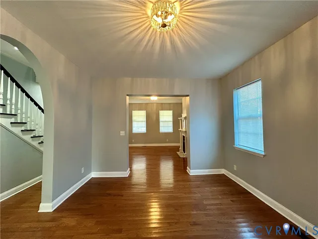 a room with wooden floor and windows