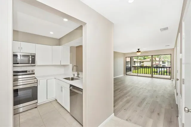 a kitchen with stainless steel appliances granite countertop a stove and a refrigerator