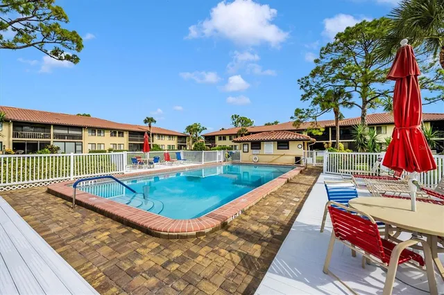 a view of house with swimming pool outdoor and patio
