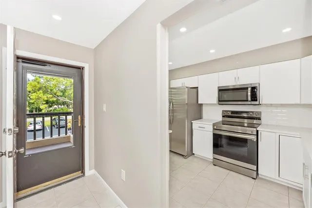 a kitchen with stainless steel appliances granite countertop a refrigerator and a stove