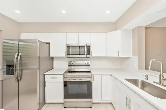a kitchen with a sink stainless steel appliances and cabinets
