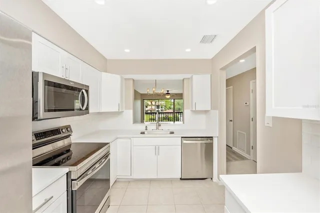 a kitchen that has a sink and a stove in it