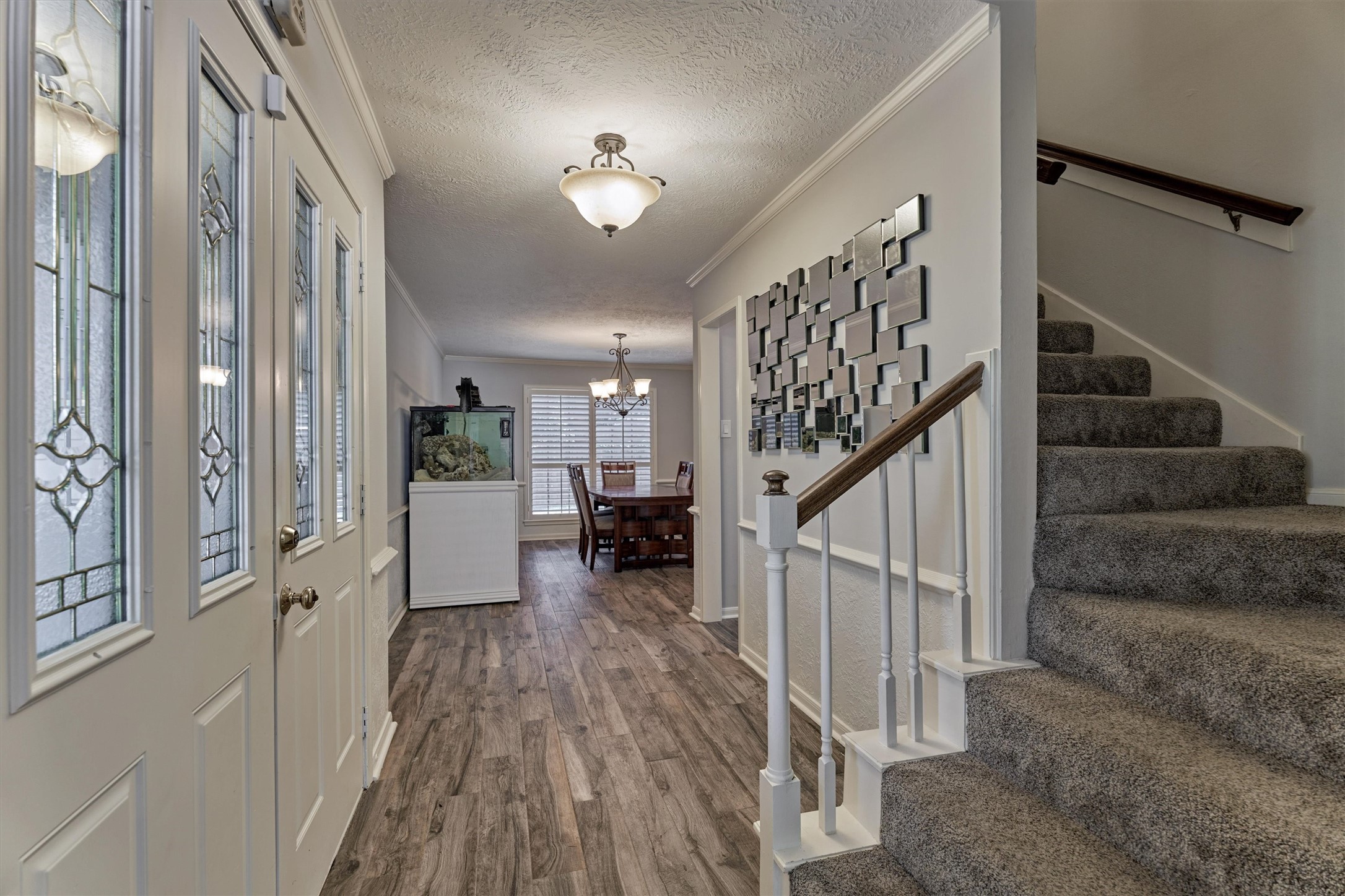 6522 Castle Pine Lane Spring, TX 77379 - Photo 9 of 49 a view of a hallway with wooden floor and staircase