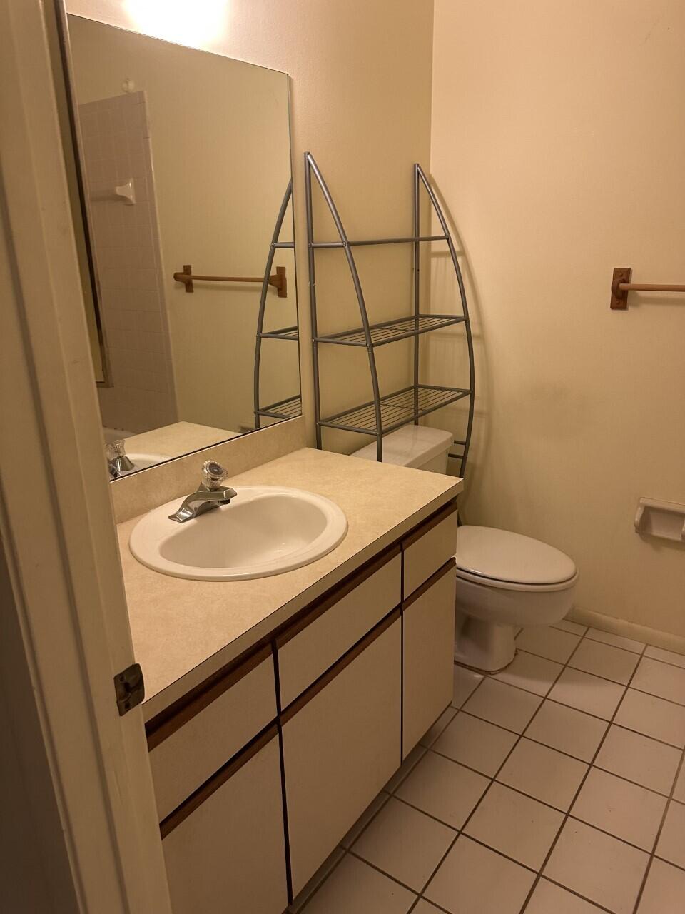 65 Maplecrest Circle Jupiter, FL 33458 - Photo 11 of 31 a bathroom with a sink toilet and mirror