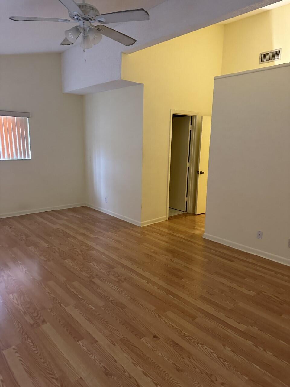65 Maplecrest Circle Jupiter, FL 33458 - Photo 13 of 31 an empty room with wooden floor and a window