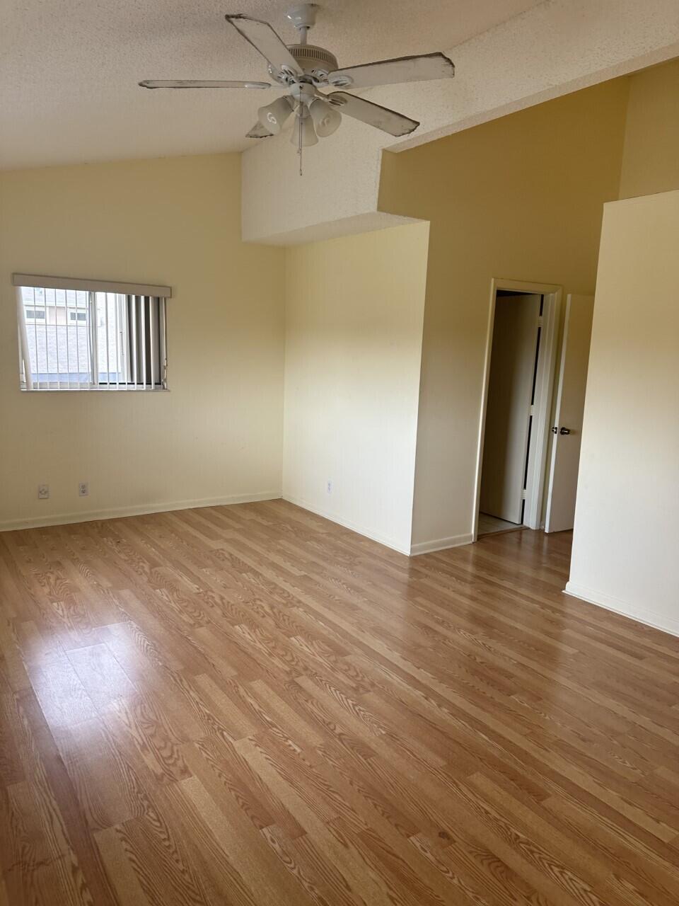 65 Maplecrest Circle Jupiter, FL 33458 - Photo 14 of 31 an empty room with wooden floor and fan