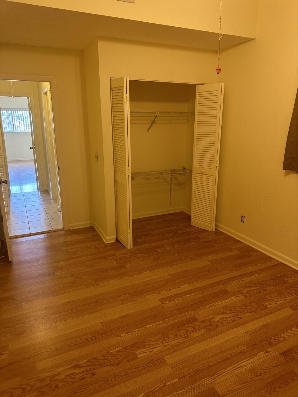 65 Maplecrest Circle Jupiter, FL 33458 - Photo 16 of 31 an empty room with wooden floor and entrance