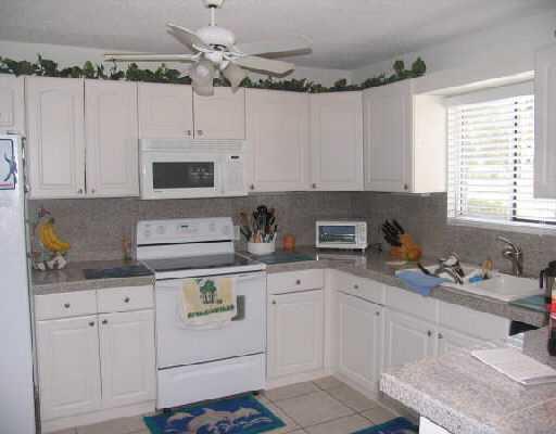 65 Maplecrest Circle Jupiter, FL 33458 - Photo 4 of 31 a kitchen with cabinets appliances a sink and a window