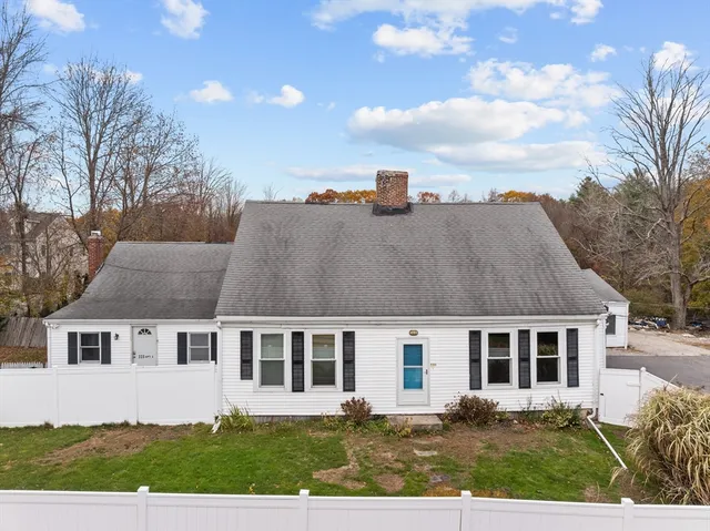 a aerial view of a house next to a yard