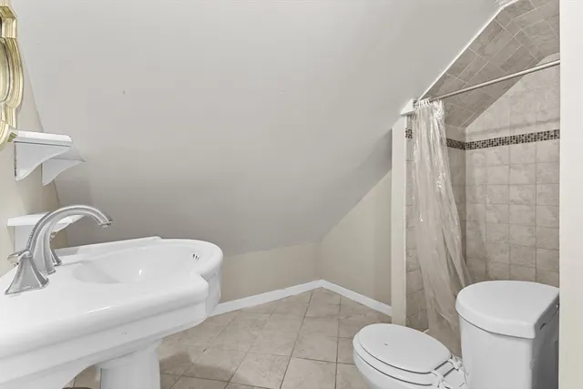 a white toilet sitting next to a bathroom sink