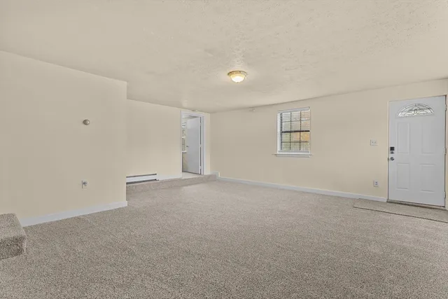 a bedroom with a bed and a view of kitchen