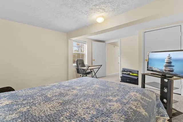 a bedroom with a bed and a table