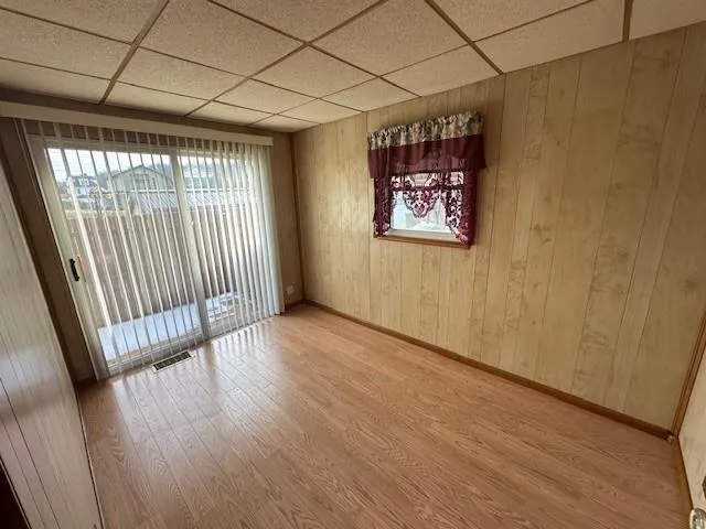 a view of an empty room and wooden floor