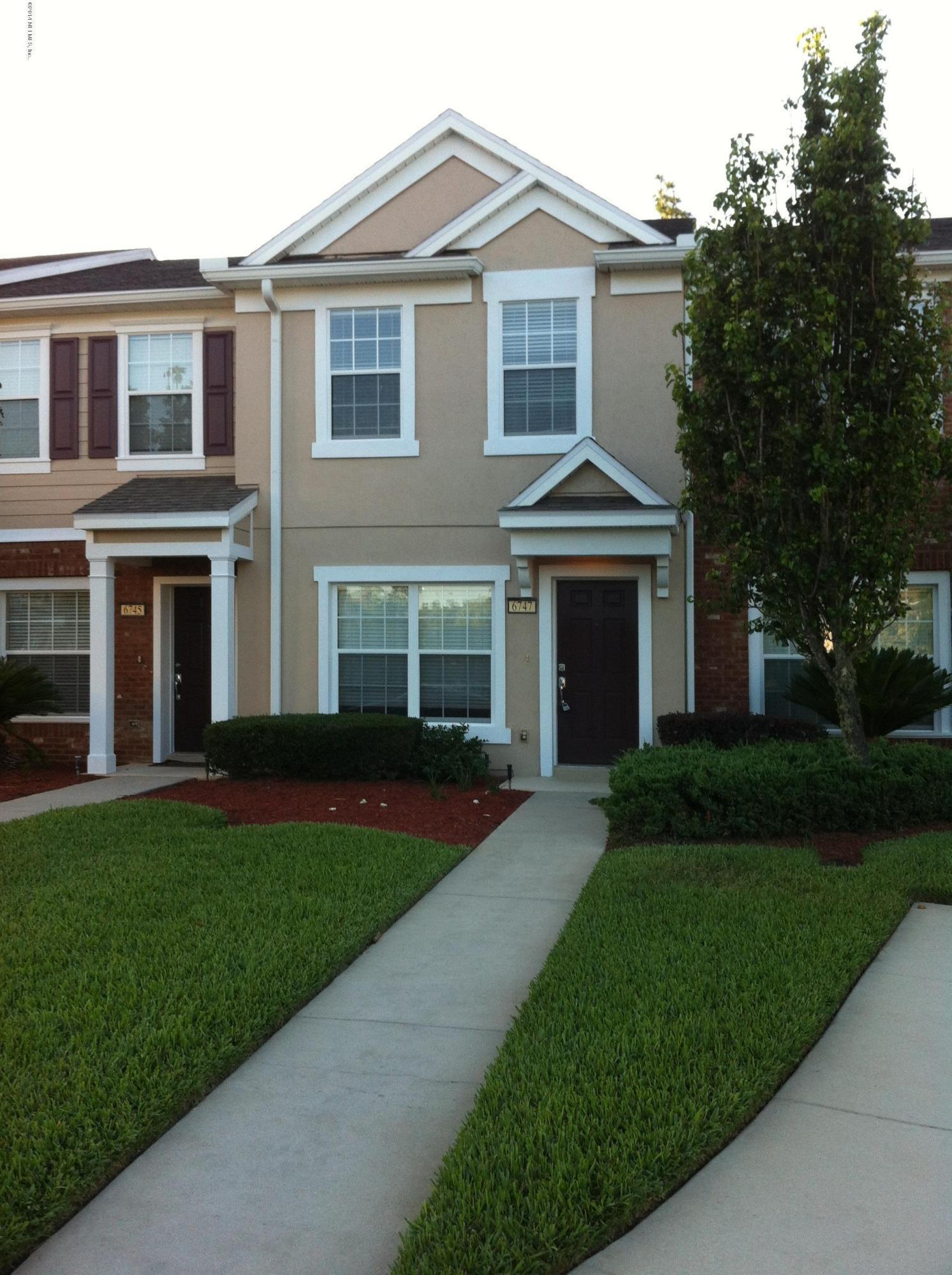 6747 Arching Branch Circle Jacksonville, FL 32258 - Photo 25 of 25 a front view of a house with a garden