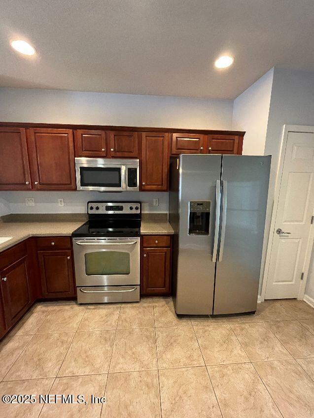 6747 Arching Branch Circle Jacksonville, FL 32258 - Photo 6 of 25 a kitchen with a stove and a microwave