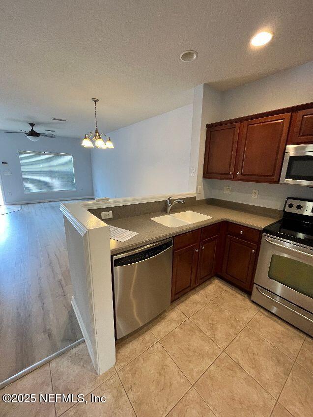 6747 Arching Branch Circle Jacksonville, FL 32258 - Photo 7 of 25 a kitchen with stainless steel appliances granite countertop a sink counter space and cabinets