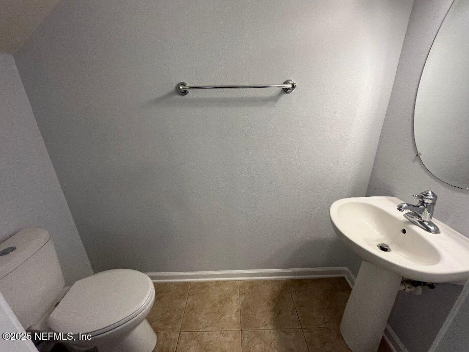 6747 Arching Branch Circle Jacksonville, FL 32258 - Photo 8 of 25 a white toilet sitting next to a bathroom sink