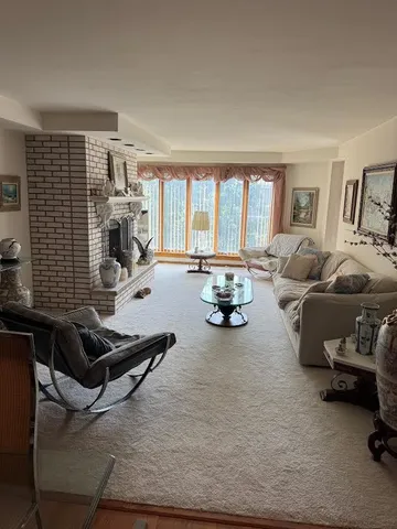 a living room with furniture gym equipment and a large window