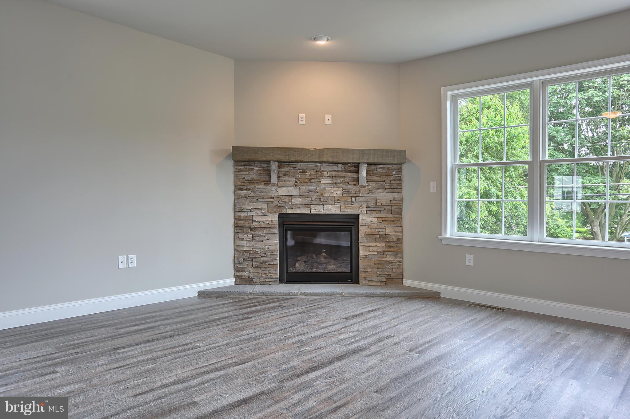 3 Rolling Meadow Road Lebanon, PA 17046 - Photo 12 of 34 an empty room with wooden floor fireplace and windows
