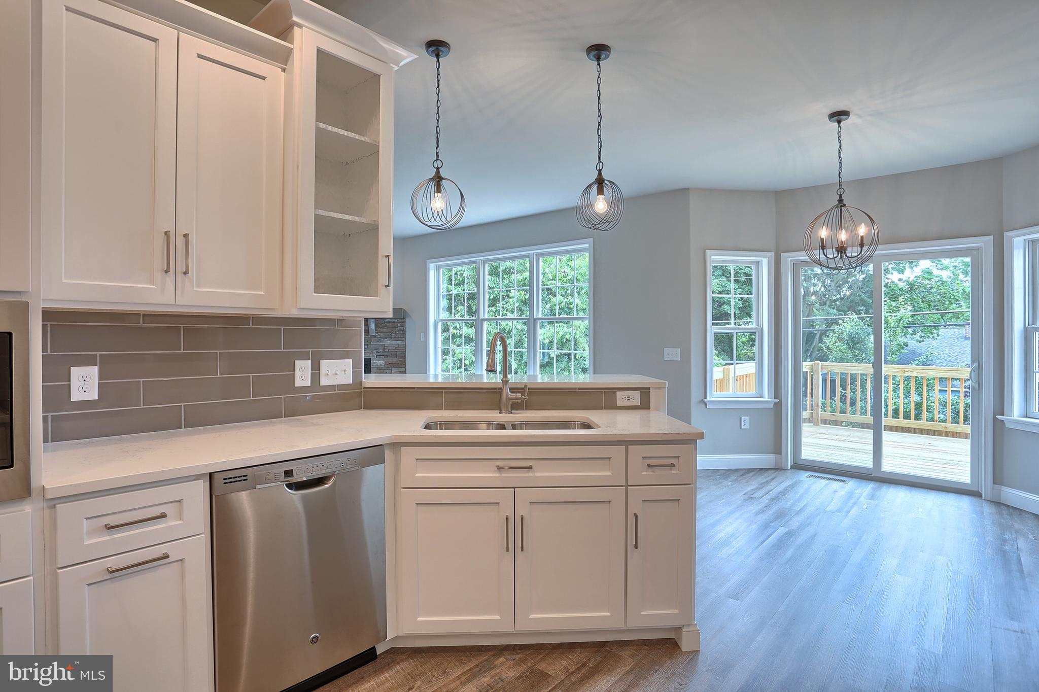 3 Rolling Meadow Road Lebanon, PA 17046 - Photo 16 of 34 a kitchen with kitchen island granite countertop a stove a sink a center island and wooden floor