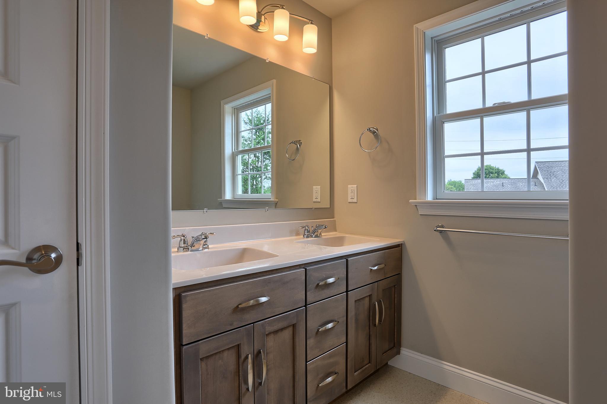 3 Rolling Meadow Road Lebanon, PA 17046 - Photo 20 of 34 a bathroom with a granite countertop sink a mirror and a window