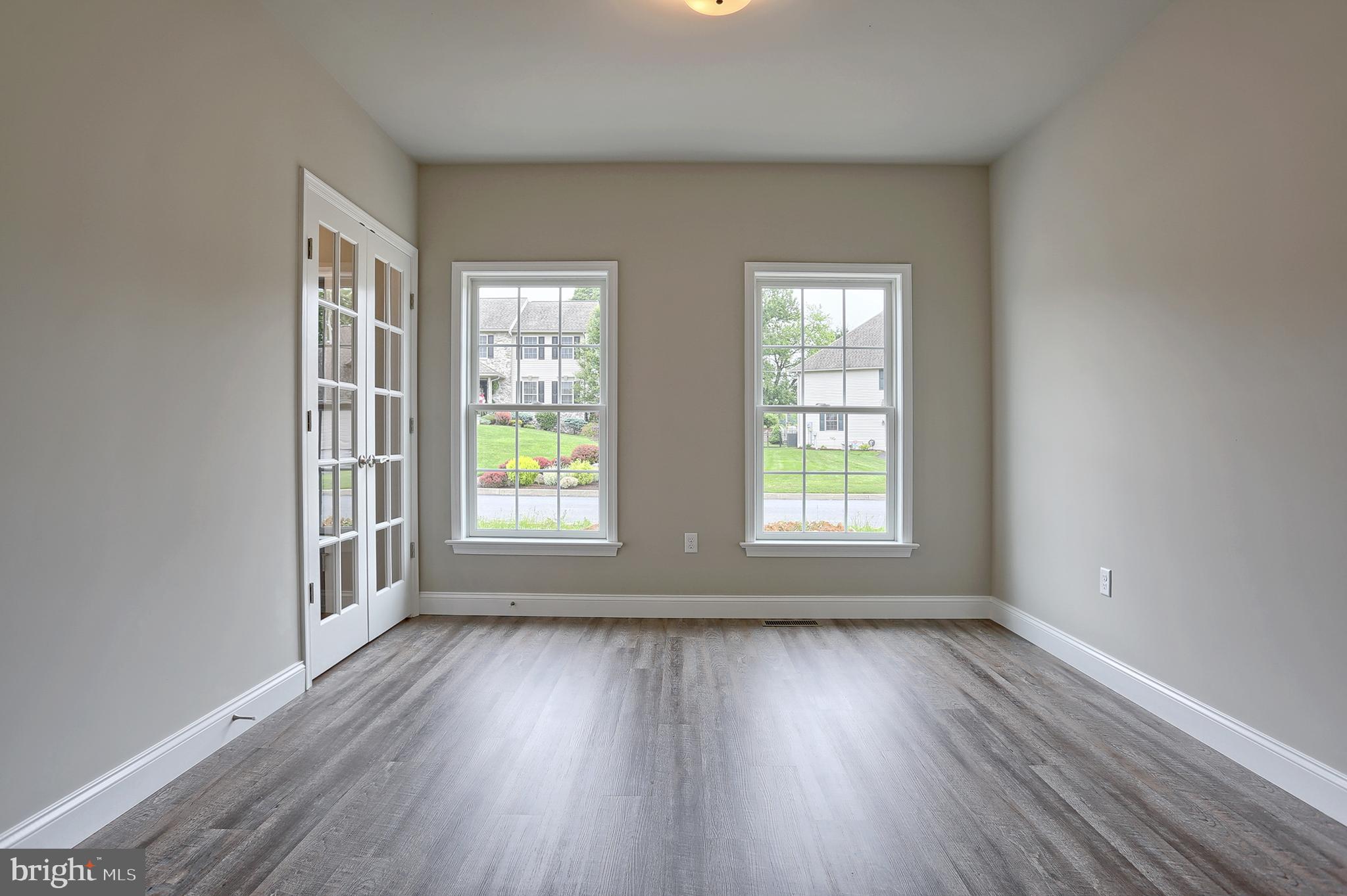 3 Rolling Meadow Road Lebanon, PA 17046 - Photo 5 of 34 a view of an empty room with wooden floor and a window