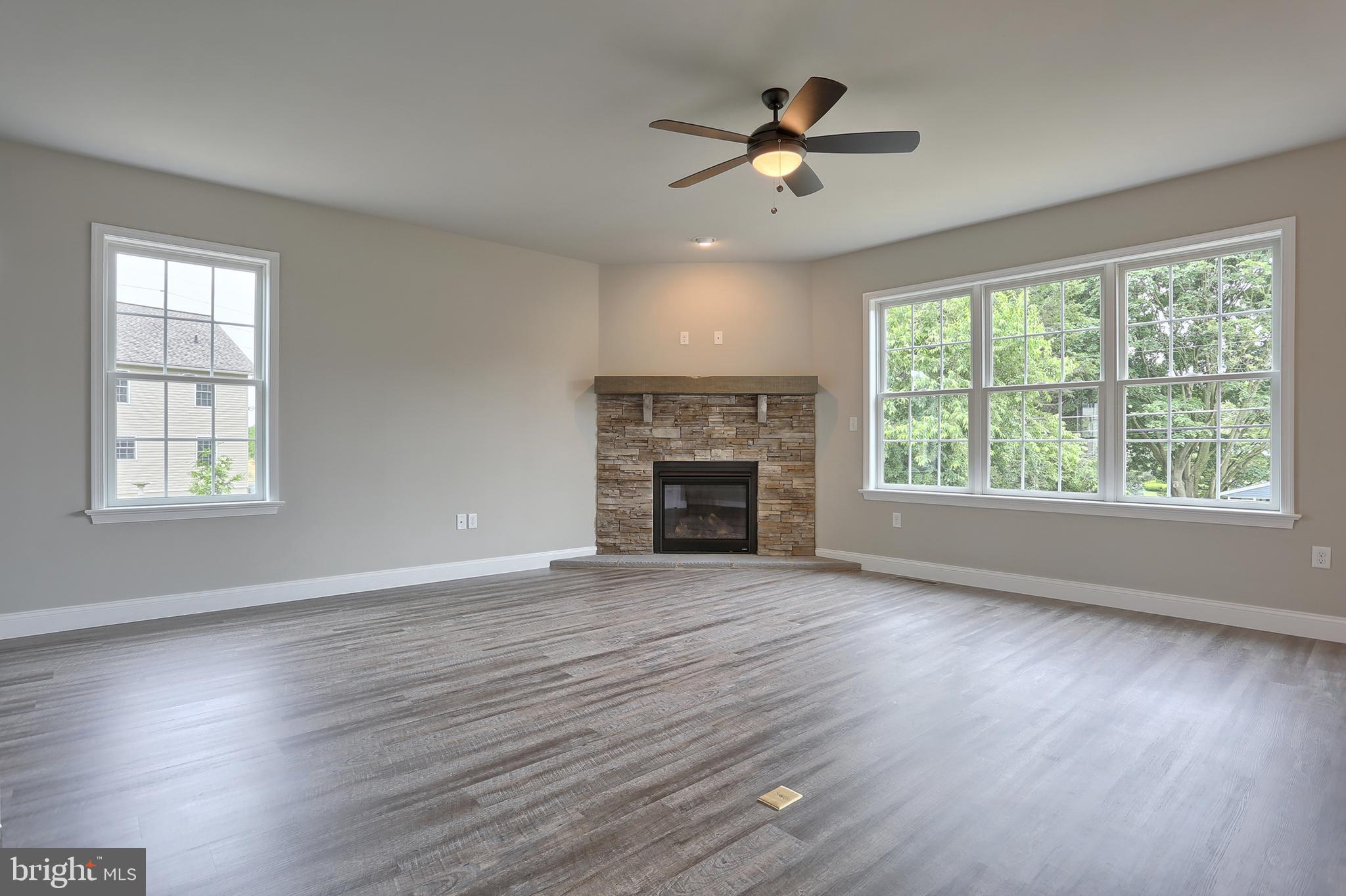 3 Rolling Meadow Road Lebanon, PA 17046 - Photo 9 of 34 an empty room with wooden floor fireplace and windows