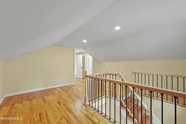 a view of hallway with wooden floor