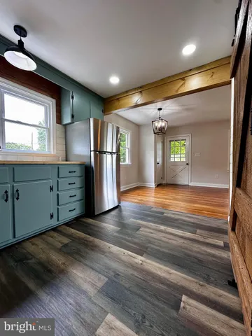 a view of an empty room with window and cabinet