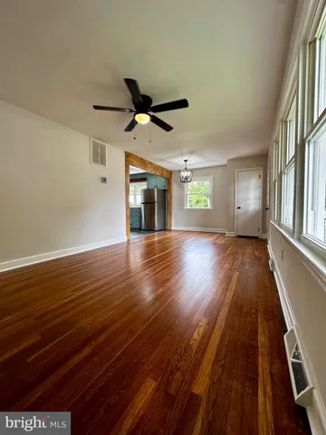 wooden floor in an empty room with a window