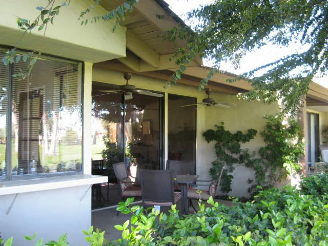 front view of a house with potted plants and a fountain
