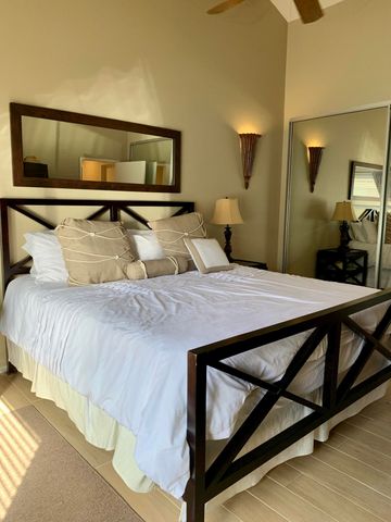 a bedroom with a bed and lamp