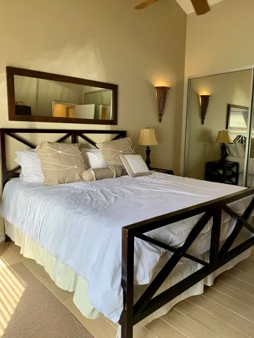 a bedroom with a bed and lamp