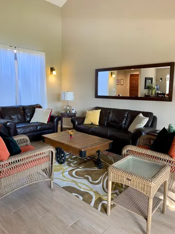 a living room with furniture and wooden floor