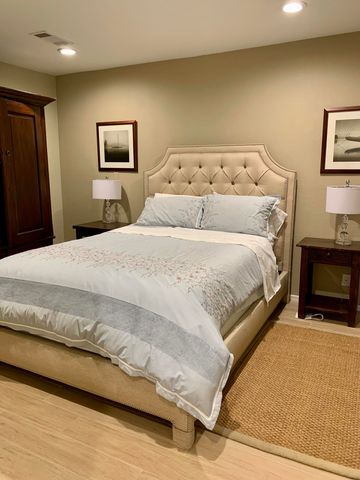 a bedroom with a bed and a couch