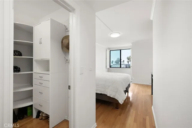 a bedroom with a bed and a view of kitchen
