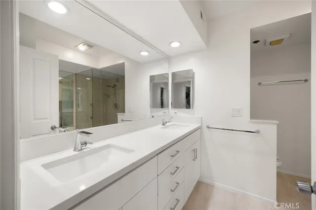 a bathroom with a double vanity sink mirror and double