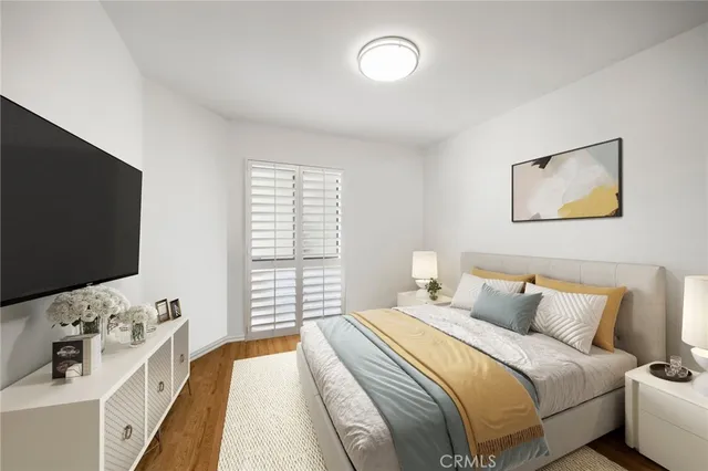 a bedroom with a bed and a flat screen tv