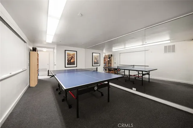 a room with furniture pool table and window