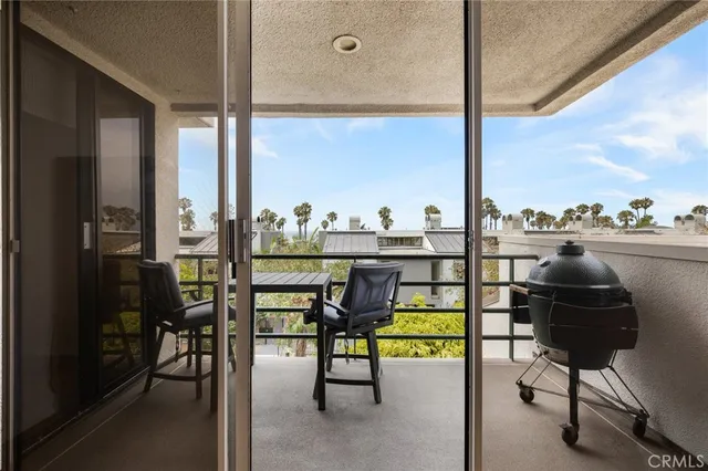 a view of a chairs and table in the balcony