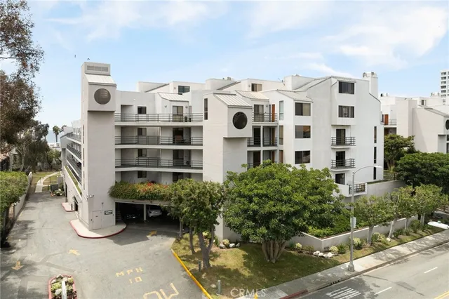 a view of a building with a yard and sitting space