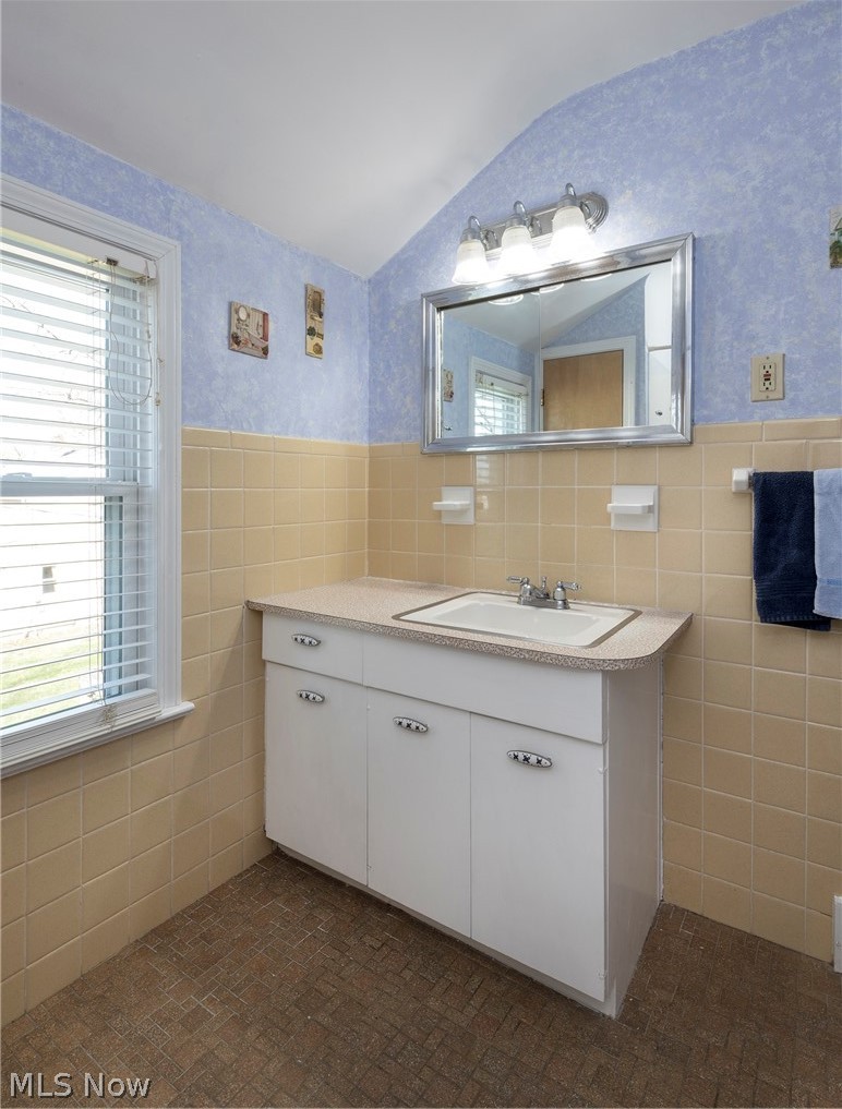 1170 Roland Road Lyndhurst, OH 44124 - Photo 24 of 36 Bathroom with vanity, tile walls, tasteful backsplash, and plenty of natural light