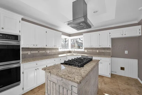 a kitchen with stainless steel appliances granite countertop a sink stove and cabinets