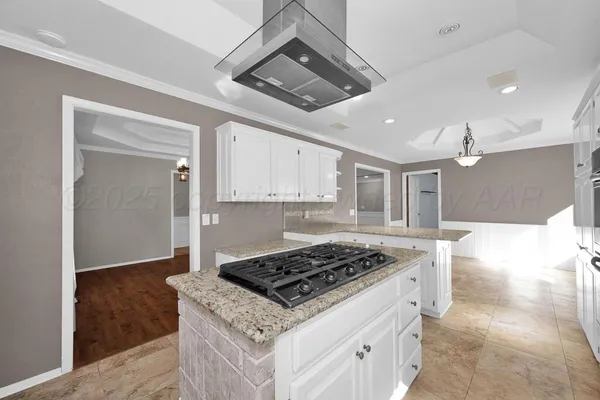 a kitchen that has a stove and a wooden floor