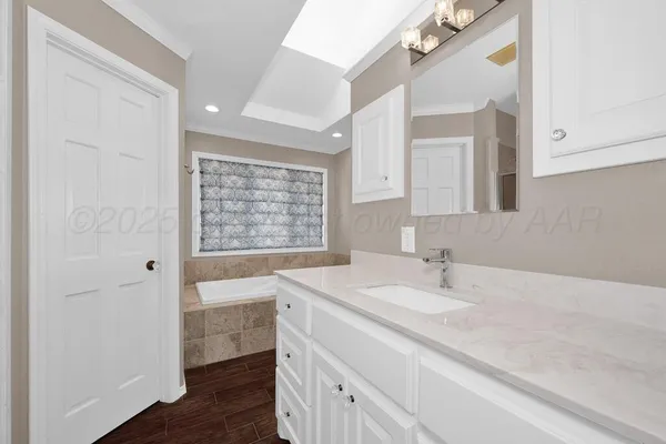 a bathroom with a sink a vanity and a large mirror